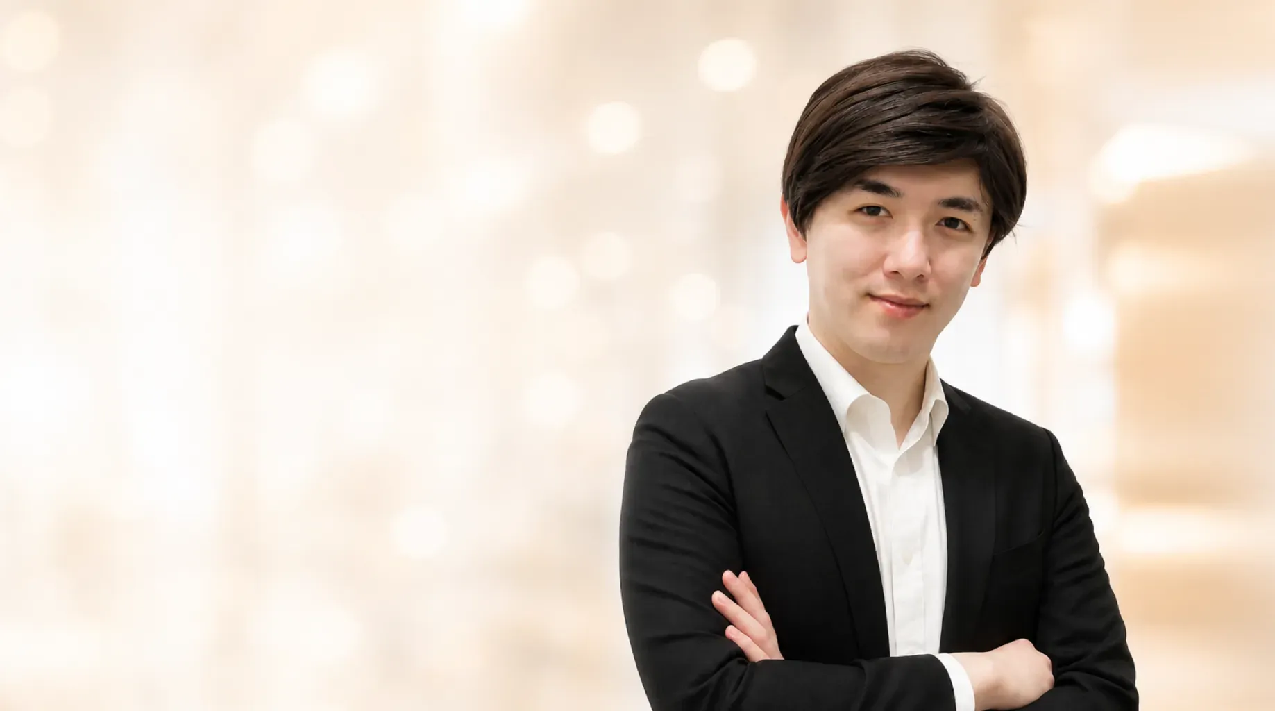Professional headshot of Kazusa Tsubota in a dark suit and white shirt